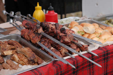Roasting juicy meat steak with spices and herbs in burning charcoals fire on bbq grid, flames and smoke. Juicy steak with grilling stripes ready for picnic celebration. Barbecue grillの写真素材