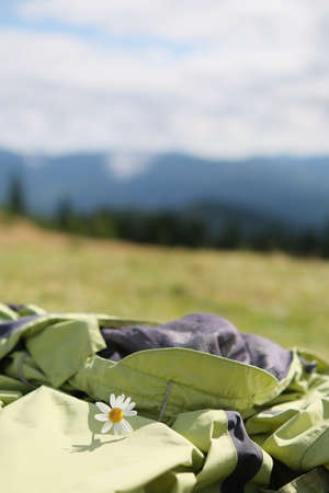 chamomile lying on coat at mountains background.の写真素材