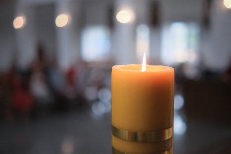 Big candle burning in a church interior.の写真素材
