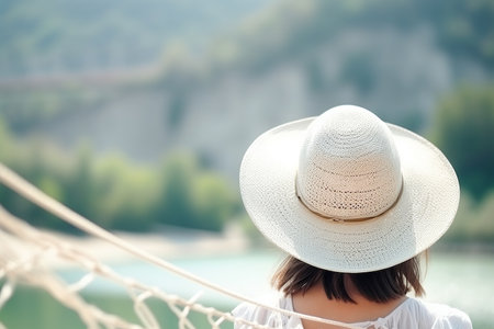 Rear view of girl in white summer hat. Generative AI.の素材