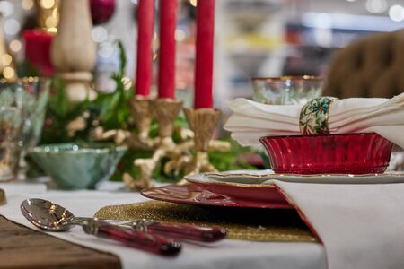 christmas dinner with glasses and ornaments over tableの写真素材