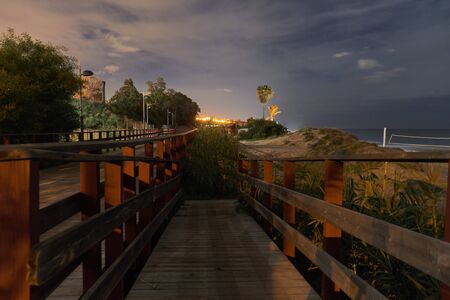 Marbella promenade at night in wood pathの写真素材