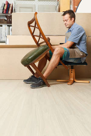 Qualified workman upholstering furniture in repair furniture workshopの写真素材