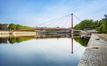 Wide red bridge over the Soane Lyon city in Franceの写真素材