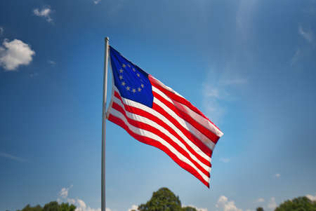 An American flag waving in the breeze.の写真素材