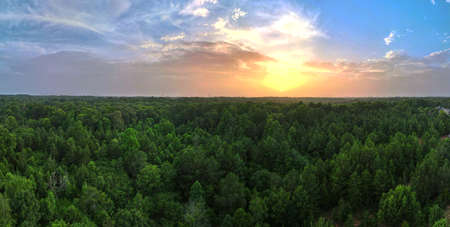 An aerial view of a beautiful sunset on the horizon with clouds in a blue sky..の写真素材