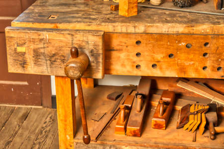 An 18th century bench vise, bench and several block planes for woodworking.の写真素材