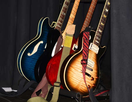 Electric guitars on a stand on a job.