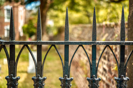A beautiful old wrought iron fence or gate with a blurred background.の写真素材