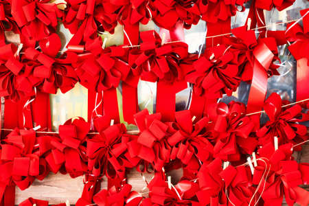 Rows of handmade red Christmas bows in a shop.