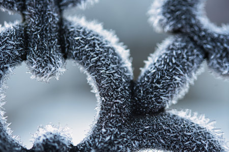 A close up of a heavy frost on a metal chair in the early morning.