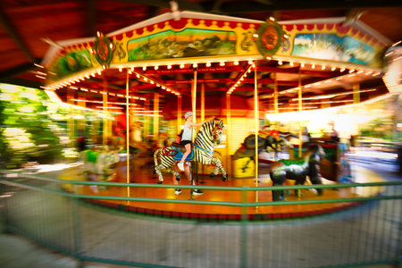 A panned shot of a colorful carousel showing motion.のeditorial素材