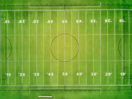 An overhead view of a football field showing the yard lines and numbers.