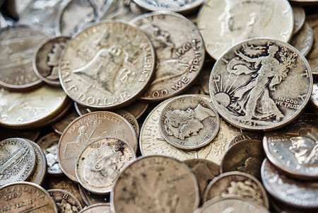 Pile of old American silver coins. Selective focus with shallow depth of field.の写真素材