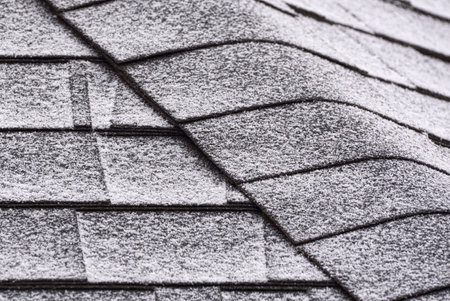 roof shingles covered with snow. close-up. winter background