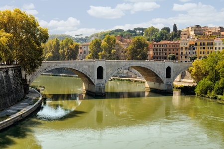 The historic stone bridge over the River Tiber in Rome.の写真素材