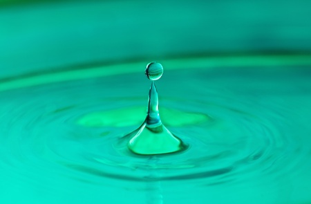 Falling drops of water. Splash effect after collision a falling drop with water surface.
