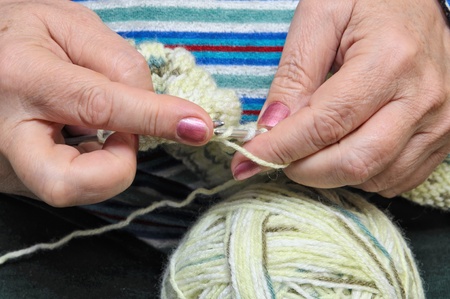 An unrecognizable woman knitting. Closeup of knitting woman