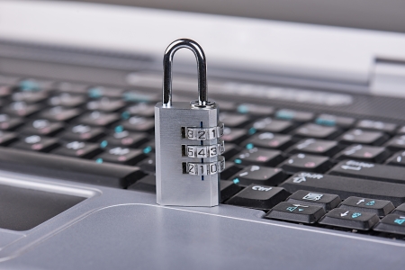 Closeup of a combination padlock on a laptop  Focus on combination lock