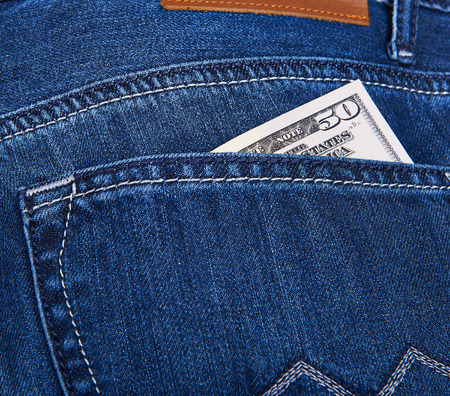 50 Dollars bill sticking out from a blue jean pocket. Closeupの写真素材
