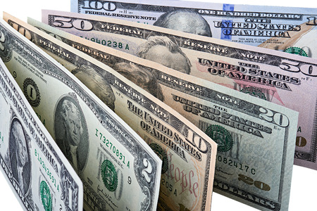 Closeup of row of dollar banknotes. Image is isolated on white and the file includes a clipping path.の写真素材