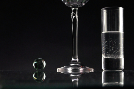 Wine glass on glass deskの写真素材