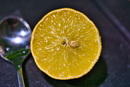 Close-up of a cut lemon and a teaspoonの写真素材