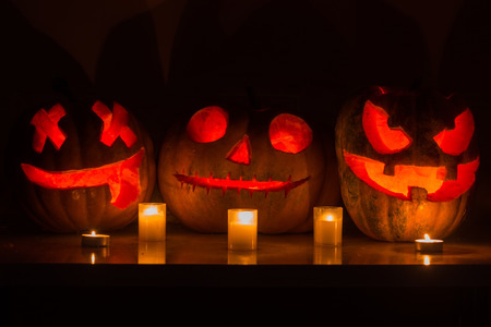 Halloween pumpkins with scary face and burning candle の写真素材