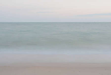 Blur photo of waves on the beachの写真素材