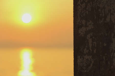 The old pole on the beach in sunsetの写真素材
