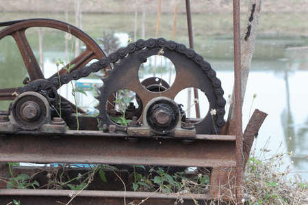 Old, dirty and rusty gear leave on the meadow