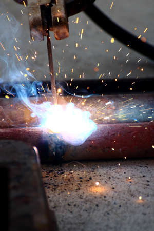 Used pipes are weld together on the groundの写真素材