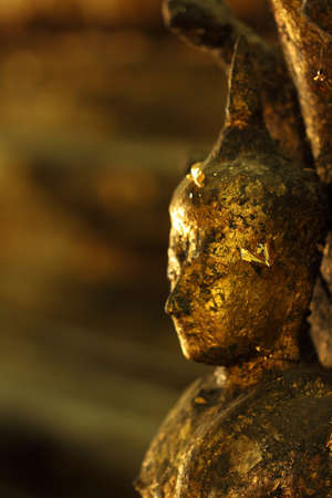 Close up capture of the old bronze sculpture of Buddhaの写真素材