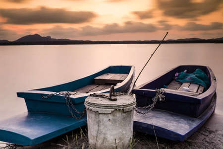 long exposure shot of two boats tied togetherの写真素材