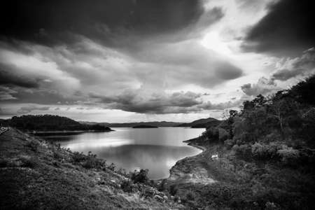 Cloudy sky over the lake in black and whiteの写真素材