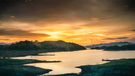 Cloudy sunset over the lakeの写真素材