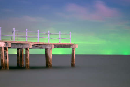 Light pollution at gulf of Thailand, green light at the horizontal of the sea come from fishing boatの写真素材