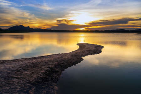 Sunset in the cloudy day at the lakeの写真素材