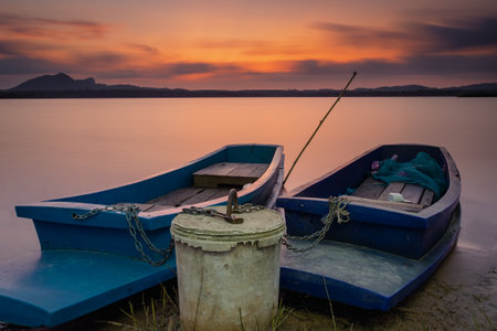 Two boats tide together at the lakeの写真素材
