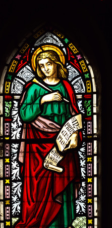 detail of viktorian stained glass church window in Fringford depicting St John the Evangelist, a scroll in his hands with the beginning of his gospel in latin "In principio erat verbum" detail of viktorian stained glass church window in Fringford depicting St John the Evangelist, a scroll in his hands with the beginning of his gospel in latin "In principio erat verbum"