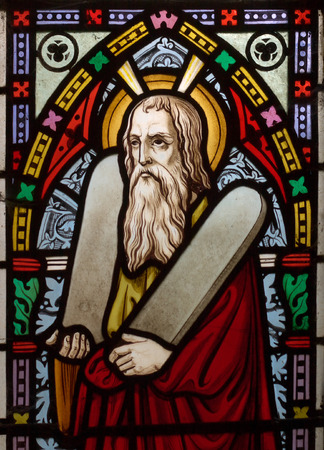 detail of victorian stained glass church window in Fringford depicting Moses with the tablets of covenant in his arms, interestingly without text, means he is pictured before climbing Mount Sinaiのeditorial素材