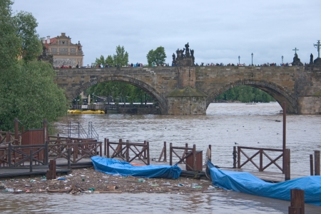 PRAGUE, CZECH REPUBLIC - JUNE 2: Boats on Vltava river during the flood, Charles Bridge in the background, on June 2, 2013 in Prague, Czech Republicのeditorial素材