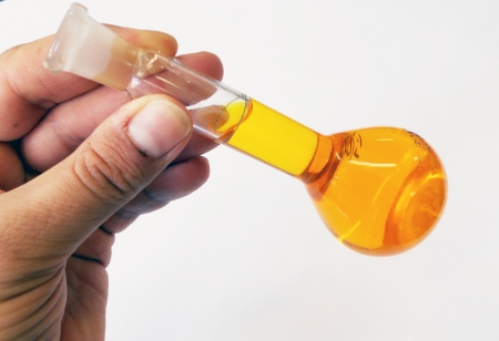 A Filled Volumetric Flask held in handの写真素材