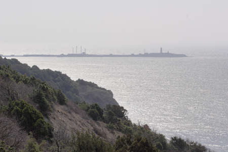 view of the sea and the rock in the morning hazeの写真素材