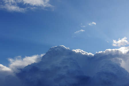 thunderous rain clouds on a blue sky backgroundの写真素材