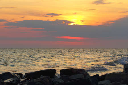 seascape bright sunset on a rocky shoreの写真素材