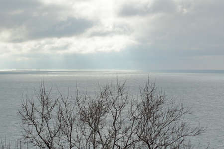 landscape horizon over the sea at full calm light through the cloudsの写真素材