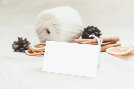 blank card mockup, business card, place card, ift tag, price tag, message card, Gift box wrapped in brown craft paper, wrapped in craft paper and tied with twine.の写真素材
