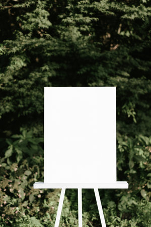 Blank white canvas wedding sign mockup on wooden easel in green garden outdoor - vintage filterの写真素材