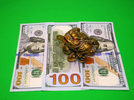 three-legged frog bringing luck and banknotesの写真素材